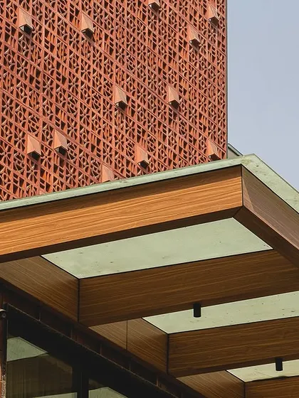 A close-up of the facade of The Brick House in Gurgaon. We used a custom terracotta jali screen, which adds a layer of intricate texture and plays with light and shadow, demonstrating our passion for using traditional materials in innovative and contemporary ways.