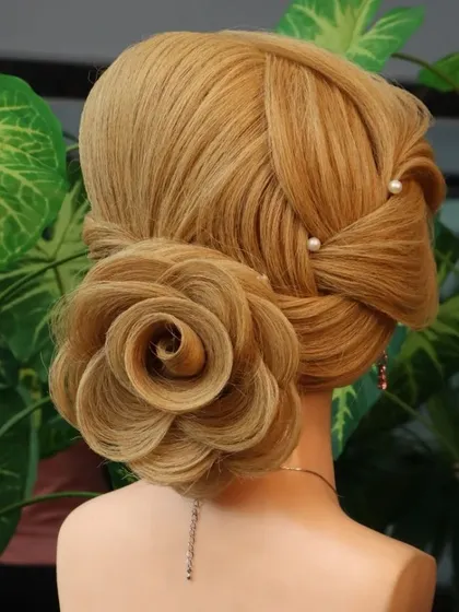 The rose bun is a student favorite. The hair on this dummy has enough texture and length to form beautiful, distinct petals, which is essential for practicing this popular and romantic updo.