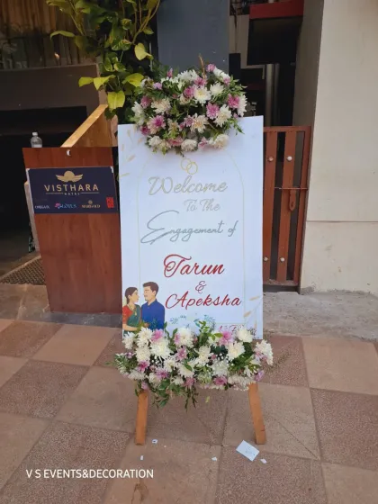 A personalized welcome sign is the first thing your guests see. For this engagement, I created a custom easel board with the couple's names and illustration, decorated with fresh floral arrangements to set a warm and inviting tone for the celebration.