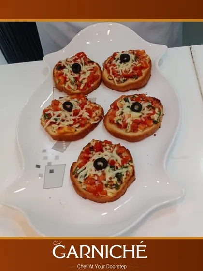 Looking for some Italian flair? We prepare these delicious bruschetta bites, topped with fresh tomatoes, cheese, and olives, perfect for passing around as an appetizer.