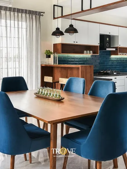 Here is how my tiles can bring a space together. This open-plan dining and kitchen area features a deep blue subway tile backsplash that adds a pop of color and texture, creating a sophisticated yet welcoming atmosphere for family meals.