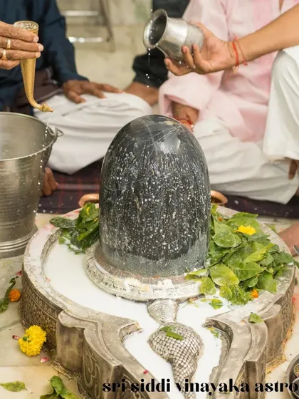 The sacred ritual of Abhishekam, seen here being performed on a Shiva Lingam, is a cornerstone of spiritual practice that I guide my clients through. This act of devotion during festivals like Shravan Shivaratri helps in cleansing karma and seeking divine grace for spiritual growth.
