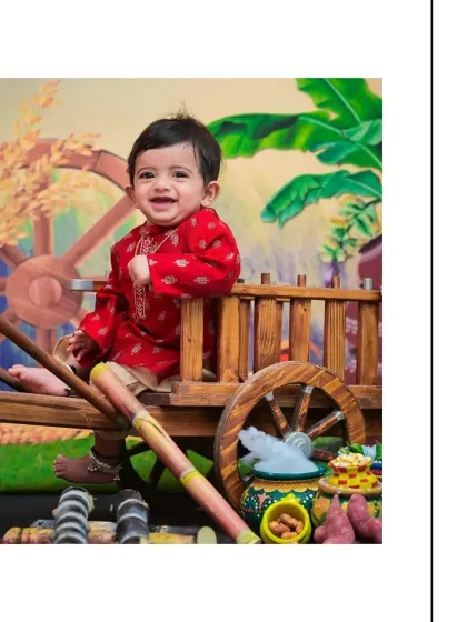 Celebrating the harvest festival with a big smile, this little boy is dressed in a traditional red kurta for his Sankranthi photoshoot. I use vibrant backdrops and props like the bullock cart and sugarcane to make festive sessions special.