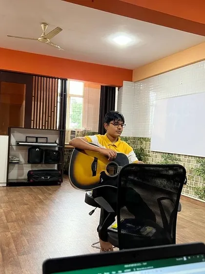 A young student focuses on his acoustic guitar during a lesson at our Bangalore studio. We provide one on one attention to ensure every student builds a strong technical and theoretical foundation.