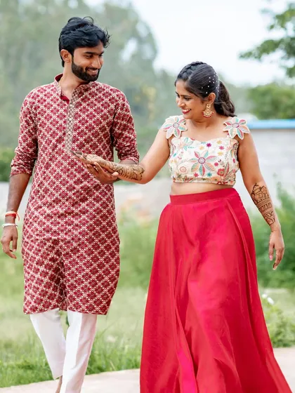 A sweet photo of the couple during their pre-wedding shoot, with her beautiful mehendi on display.