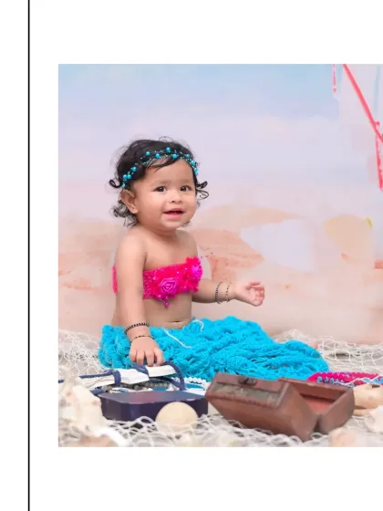 A beautiful baby girl dressed as a little mermaid, complete with a colorful tail and seashell props. My fantasy-themed sessions, like this under the sea adventure, are perfect for creating magical portraits.
