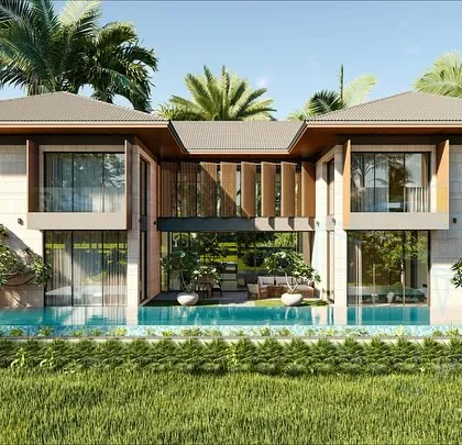 This 5000 sq ft villa in Goa is designed to embrace its tropical setting. The architecture blends traditional Goan elements with a modern aesthetic, featuring large glass panels and an open layout that connects the interior living spaces directly to the paddy fields beyond.