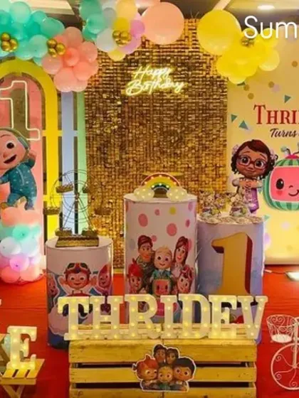 I created this complete Cocomelon themed first birthday party setup, featuring a custom backdrop, character cutouts, a multi-colored balloon arch, and personalized name blocks. This is a great example of a full-package event decoration.