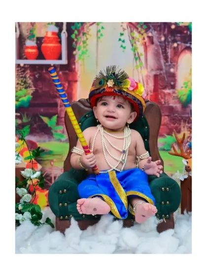Here is a joyful Little Krishna, holding his flute with a happy grin. My cultural and festive photoshoots are designed with beautiful details, from the peacock feather crown to the traditional attire, to celebrate your heritage.
