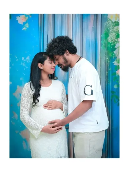 Sometimes the simplest moments are the most powerful. This intimate portrait focuses entirely on the couple's connection, with a clean and bright backdrop that doesn't distract from their emotion. It’s a beautiful example of a modern, minimalist couple's maternity photo.