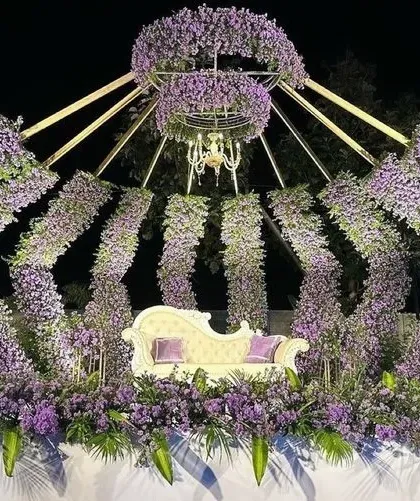 For a truly unique reception, we designed this royal crown-inspired stage. The structure is made of arches densely packed with purple flowers, with a beautiful chandelier at the center. It’s a bold and unforgettable backdrop that will make you feel like royalty on your special day.