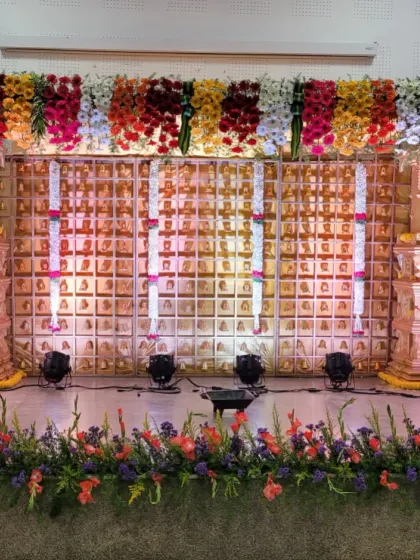 For clients who want to go all out, I designed this grand, temple-themed stage for a baby shower. The backdrop features hundreds of small bells, framed by large pillars and topped with a thick canopy of multi-colored flowers.