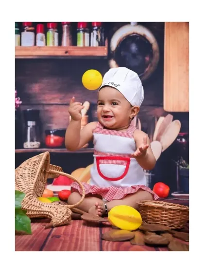 Here is a shot from my popular 'Little Chef' theme. This little one is having a blast playing with props in a miniature kitchen setup, creating such a playful and dynamic portrait.