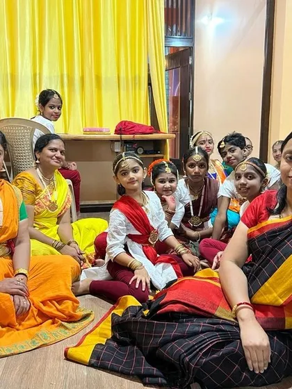 A quiet moment with my students before an examination. Dressed in traditional attire, they are ready to perform. I make it a point to create a supportive and calm atmosphere, helping them build confidence before they showcase their art.