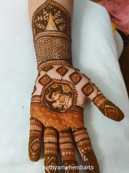A unique design featuring a central elephant motif surrounded by geometric patterns and a temple design on the wrist.