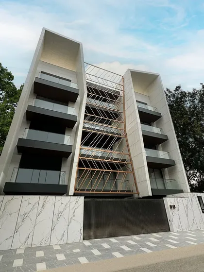 The Terrazzo House in Gurgaon showcases our experimental approach to materials and form. The building's facade features bold, angled structures clad in white terrazzo, creating a unique and sculptural statement in the urban landscape.