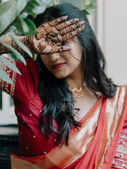 A client testimonial photo where she peeks through her mehendi-adorned hand. I am so grateful for such kind words about my work and organic henna.