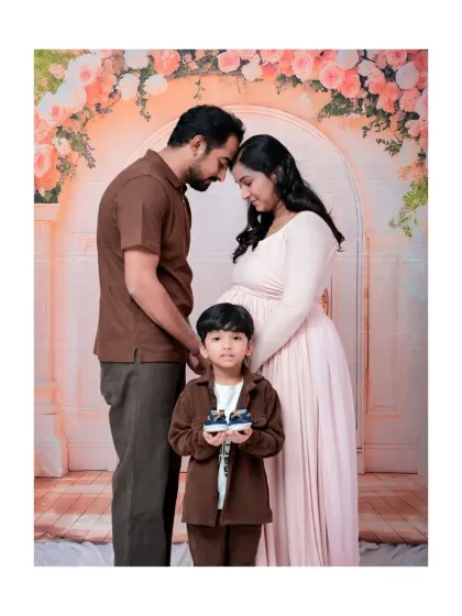 Welcoming a new baby is a family affair. Including older siblings in your maternity photoshoot is a wonderful way to capture the excitement of the soon-to-be big brother or sister. This sweet moment shows a family united in anticipation, holding the tiny shoes for their newest member.