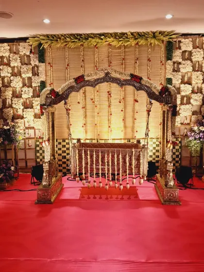 For a Namakarana, the cradle is the hero. Here, I've designed a traditional wooden cradle setup with a backdrop of woven 'chatai' mats and jasmine flowers, creating a truly divine setting for the baby's naming ceremony.