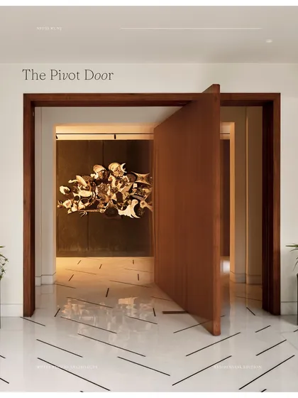 The entrance to the Rajgarhia residence sets a tone of modern, understated elegance. A custom-designed oversized pivot door opens into a minimalist foyer, where a dramatic art installation is the focal point, showcasing our approach to integrating art and architecture from the very first step.