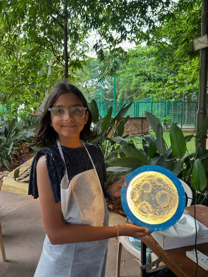 One of my most magical workshops is moon lamp making. Here, a young artist holds her finished lamp, a glowing personal creation she can take home. It’s a wonderful activity that lights up faces with as much joy as the lamps themselves.