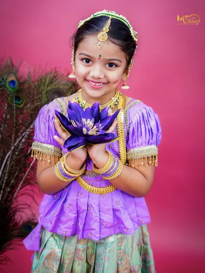 Celebrating our beautiful traditions is something I am very passionate about. This is from a 'Mogina Jade' themed shoot, capturing the grace and innocence of childhood. The vibrant colors, traditional attire, and the child's bright smile make this a truly timeless portrait.