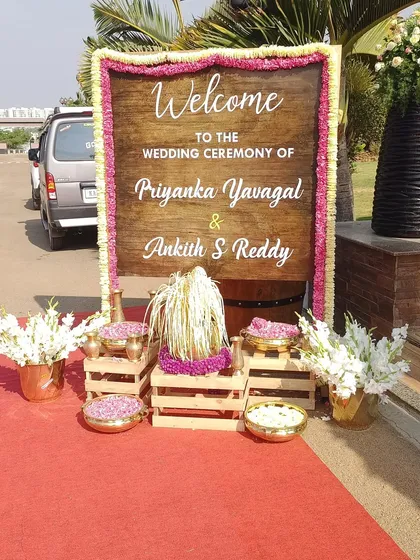 The first thing your guests see should be special. I designed this rustic wooden welcome board, framed with delicate pink and white flowers, to set a warm and inviting tone for the wedding ceremony of Priyanka and Ankith.