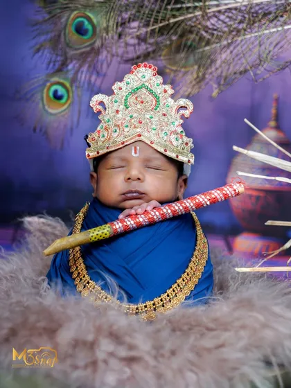 I have a huge collection of themes to make your baby's first photoshoot truly special. This Little Krishna setup is a favorite, complete with a tiny flute, peacock feathers, and a divine, sleepy expression.
